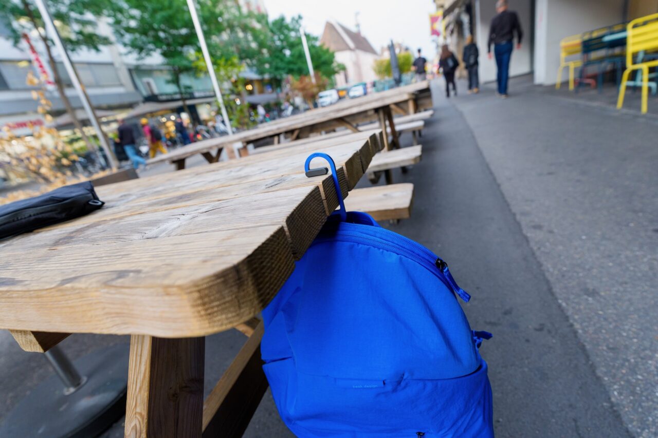 peak design crochet city line Peak Design City Backpack 22L suspendu à une table en bois avec le crochet BagLev